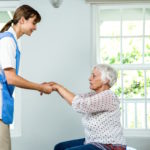 Nurse assisting senior woman