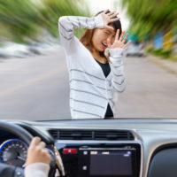 Young shocked woman screaming when being crushed by fast car on the road.