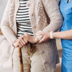 Gentle trained nurse helping mature patient