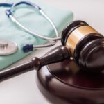 Gavel and stethoscope in background. Medical laws and legal concept.