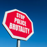 A traffic sign with the text STOP POLICE BRUTALITY to illustrate protest against murdering people by policemen