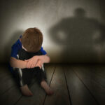 Sad Abused Boy with Anger Shadow